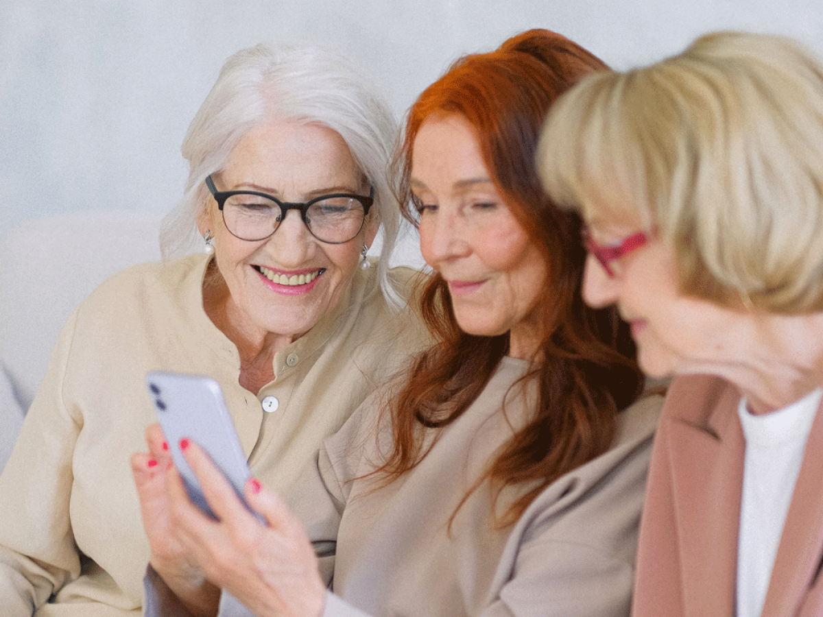 Photo of 3 people on a mobile phone